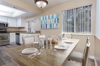 Dining and kitchen area with hardwood-style flooring